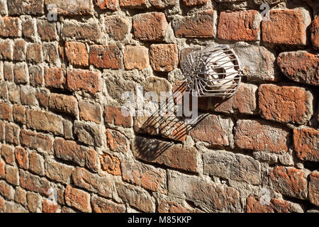 Red Brown Old Shabby Brick Wall Square Background Or Texture With Ventilation Hole. Retro Urban Brickwall Frame Wallpaper. Grungy Textured Clay Brick Wall. Distressed Brickwall Surface. Stock Photo
