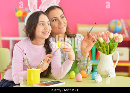 Mother and daughter colouring eggs Stock Photo
