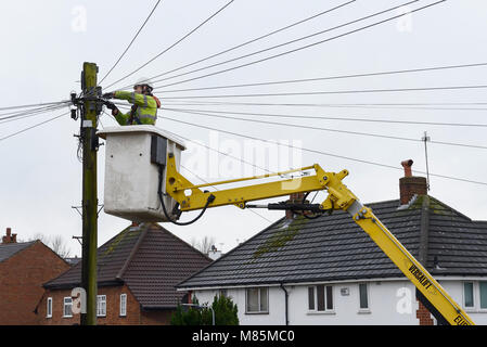 A BT Openreach engineer working on telephone cables from a cherry picker Stock Photo