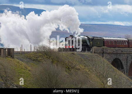 Puffing steam cloud, iconic locomotive LNER class A3 60103 Flying Scotsman, travels over arches of Ribblehead Viaduct - North Yorkshire, England, UK. Stock Photo
