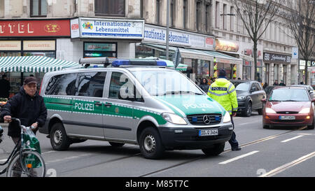 14 March 2018, Germany, Leipzig: A police car blocks the traffic on Leipzig's Eisenbahnstrasse during a police operation against drug-related and gun-enabled crime. Photo: Sebastian Willnow/dpa-Zentralbild/dpa Stock Photo