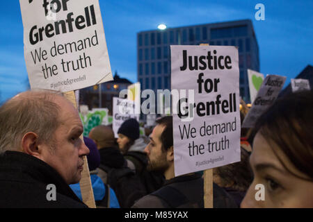 London, UK. 14th March 2018 People hold plakcards and banners during a silent march to remember those who diedin the Grenfell fire disaster. Credit: Thabo Jaiyesimi/Alamy Live News Stock Photo
