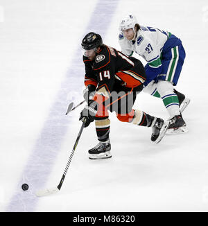 Los Angeles, California, USA. 14th Mar, 2018. Anaheim Ducks' forward Adam Henrique (14) vies with Vancouver Canucks' defenseman Ben Hutton (27) during a 2017-2018 NHL hockey game in Anaheim, California, on March 14, 2018. The Ducks won 3-0. Credit: Ringo Chiu/ZUMA Wire/Alamy Live News Stock Photo