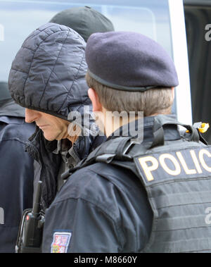 The police and state attorneys proposed that Prague High Court judge Ivan Elischer, arrested on suspicion of corruption, and another five accused in his case be remanded in custody, on which a court will decide later today, Prague district court deputy head Michal Dvorak has told CTK. On the photo police officers bring Elischer (center) to Prague district court in Prague, Czech Republic, on March 15, 2018. (CTK Photo/Katerina Sulova) Stock Photo