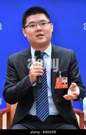 Beijing, China. 15th Mar, 2018. Li Jun, a deputy to the National People's Congress and Party Secretary of Xiuyun Village in southwest China's Sichuan Province, speaks at a press conference to share his experience on poverty alleviation in Beijing, capital of China, March 15, 2018. Credit: Li Xin/Xinhua/Alamy Live News Stock Photo