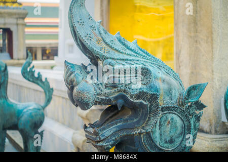 Close up of stone dragon statue located at the enter of Pranon Wat Pho, laying Buddha temple Stock Photo