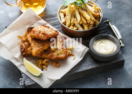 Close view of fish and chips on dark background Stock Photo