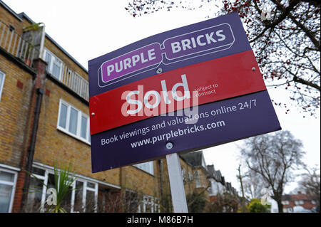 A Purple Bricks sold estate agent sign outside a house in Muswell Hill, London Stock Photo