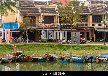 Rowing boats lined up against the bank of the Hoi An river, Hoi An, Vietnam