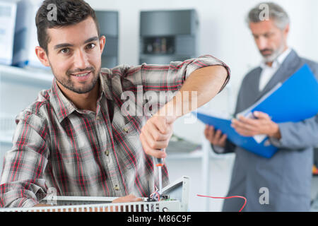 close-up of mature mechanic hands repairing heating system Stock Photo