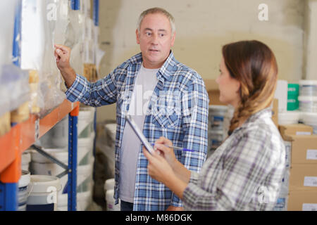 woman and man working in warehouse doing an invertory Stock Photo