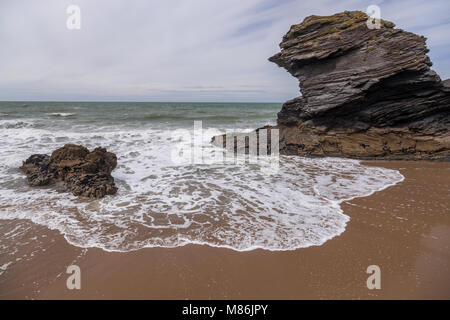Rocks and wave at Llangrannog beach at low tide, Wales coast Stock Photo