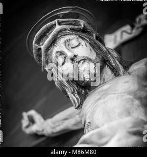 Nailed hand on wooden cross. Crucifixion of Jesus Christ. Stock Photo