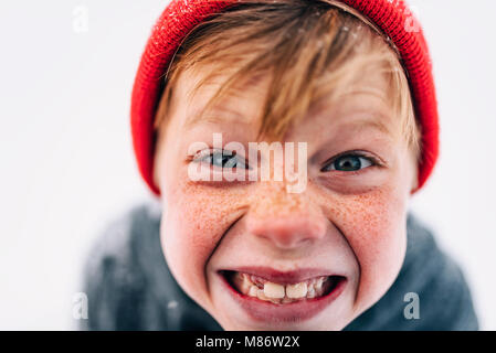 Portrait of a boy with freckles pulling funny faces Stock Photo