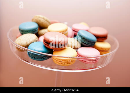 Multi-colored macaroons on a glass cake stand Stock Photo