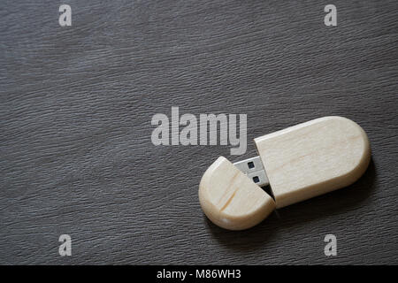 Usb flash drive with wooden surface on desk for USB port plug-in computer laptop for transfer data and backup business concept.