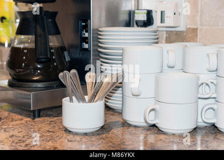 Cups, saucers and spoons. Catering supplies Stock Photo