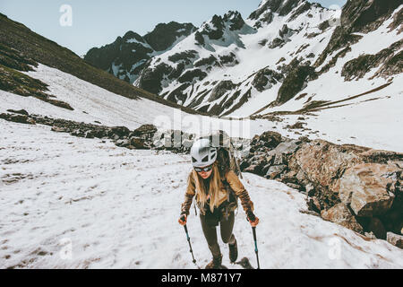 Active woman climbing in snowy mountains Travel lifestyle adventure concept extreme vacations outdoor gear Stock Photo