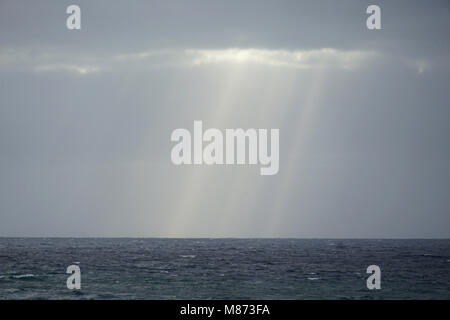 sunrays fighting their way through clouds, Atlantic Ocean beteween Sao Vincente Island and Santo Antao Island, Cape Verde Stock Photo