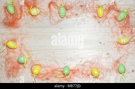 Color Easter eggs and straw wood background Stock Photo