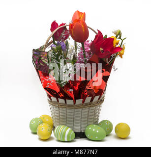 Flower arrangement in pots with Easter eggs near white background Stock Photo