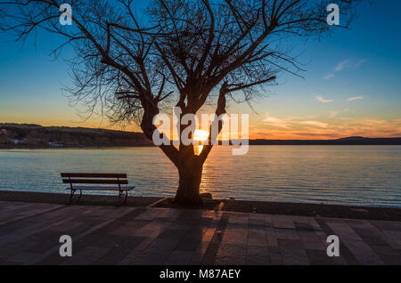 Anguillara Sabazia, Italy - The Bracciano lake at sunset from the old stone town on the waterfront. Province of Rome, central italy Stock Photo