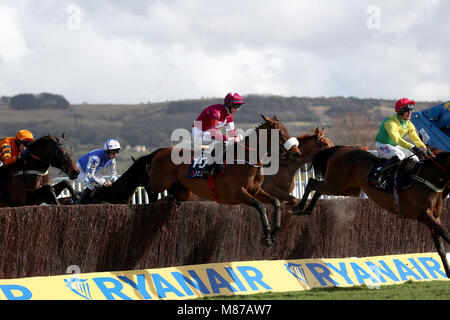 Shattered Love ridden by jockey Jack Kennedy (centre) during the first lap of the JLT Novices' Chase during St Patrick's Thursday of the 2018 Cheltenham Festival at Cheltenham Racecourse. Stock Photo