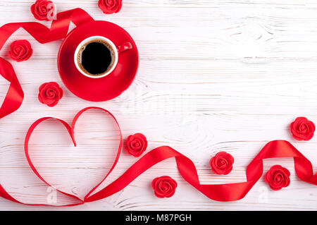 Valentines background with red heart, coffee cup and roses. Valentines Day greeting card. Top view Stock Photo