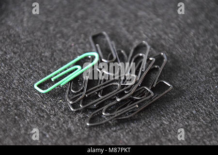 black and green paperclips on black Background Stock Photo