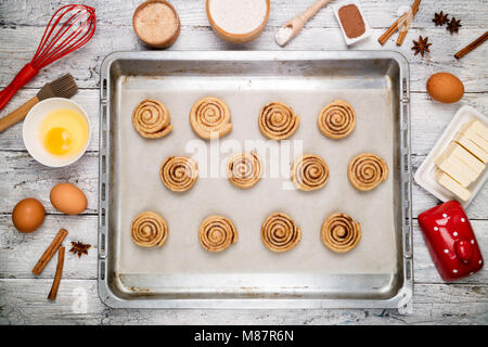 Cooking cinnamon rolls. Preparation raw dough traditional sweet dessert buns danish pastry. Baking ingredients flat lay. Top view Stock Photo