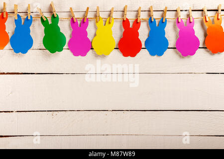 Easter garland. Festive garland with rabbits. happy Easter. White wooden background. Stock Photo