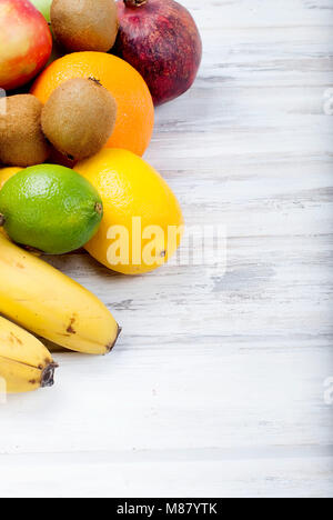 Variety of fresh citrus fruits on white background from slices of kiwi and orange ,copy space Stock Photo