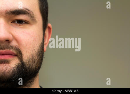 Portrait of a handsome young bearded man. Part view Stock Photo