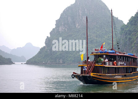 Cruising among beautiful limestone rocks in Ha Long bay, UNESCO world heritage site,  Vietnam - Chinese Junk, ancient chinese sailing ship Stock Photo