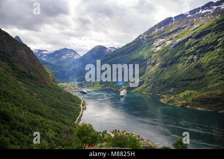 View of the Geirangerfjord with cruise boats and the village of Geiranger at the end of the fjord Stock Photo