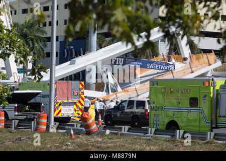 Miami, USA. 15th Mar, 2018. Police and first responders work on the scene at the footbridge collapse site in Miami, Florida, the United States, March 15, 2018. A pedestrian footbridge near Florida International University (FIU) collapsed Thursday afternoon, causing 'several fatalities,' local authorities said. Credit: Monica McGivern/Xinhua/Alamy Live News Stock Photo