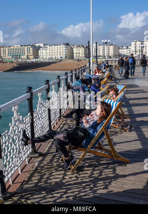 Brighton UK 16th March 2018  - Visitors enjoy the warm sunshine on Brighton Palace Pier today but the weather is forecast to turn cold again with snow expected in some parts off Britain over the weekend  Credit: Simon Dack/Alamy Live News Stock Photo