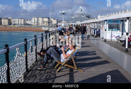 Brighton UK 16th March 2018  - Visitors enjoy the warm sunshine on Brighton Palace Pier today but the weather is forecast to turn cold again with snow expected in some parts off Britain over the weekend  Credit: Simon Dack/Alamy Live News Stock Photo