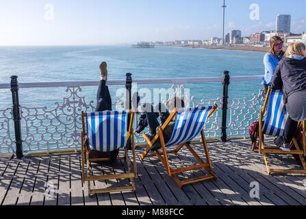 Brighton UK 16th March 2018  - Visitors enjoy the warm sunshine on Brighton Palace Pier today but the weather is forecast to turn cold again with snow expected in some parts off Britain over the weekend  Credit: Simon Dack/Alamy Live News Stock Photo