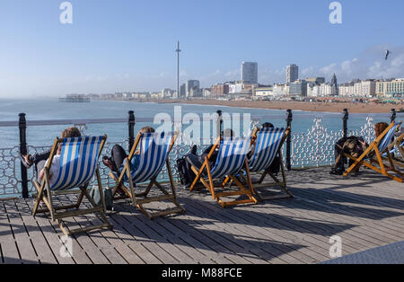 Brighton UK 16th March 2018  - Visitors enjoy the warm sunshine on Brighton Palace Pier today but the weather is forecast to turn cold again with snow expected in some parts off Britain over the weekend  Credit: Simon Dack/Alamy Live News Stock Photo