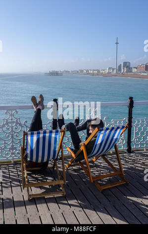 Brighton UK 16th March 2018  - Visitors enjoy the warm sunshine on Brighton Palace Pier today but the weather is forecast to turn cold again with snow expected in some parts off Britain over the weekend  Credit: Simon Dack/Alamy Live News Stock Photo