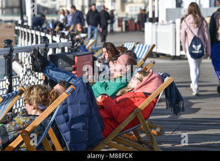 Brighton UK 16th March 2018  - Visitors enjoy the warm sunshine on Brighton Palace Pier today but the weather is forecast to turn cold again with snow expected in some parts off Britain over the weekend  Credit: Simon Dack/Alamy Live News Stock Photo