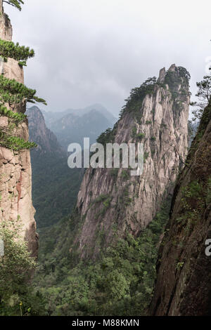 Looking though a gap towards distant mountains, Huangshan National Park, Anhui, China Stock Photo