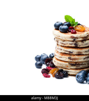 Stack  of welsh cakes with dry berries and fresh blueberries isolated on white Stock Photo