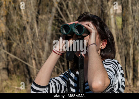 woman looking with binoculars Stock Photo