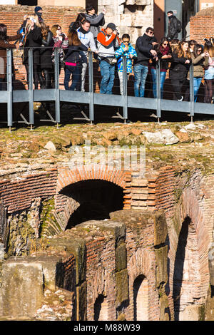 Tourists at the Colosseum or Coliseum, also known as the Flavian Amphitheatre, with the below ground level hypogeum, Rome. Lazio. Italy.