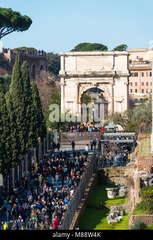 Tourists queuing to enter Palatine Hill and Roman Forum, with the Arch of Constantine to the rear. Elevated view from Colosseum, Rome, Italy.