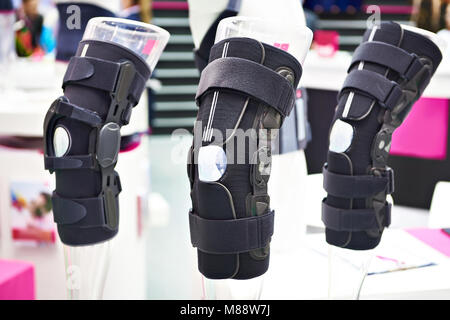 Brace on the knee joint with a sleeve made of neoprene in store Stock Photo