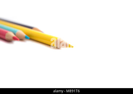 Yellow Pencil Sticking out of three other colored pencils signifying sticking out and being different