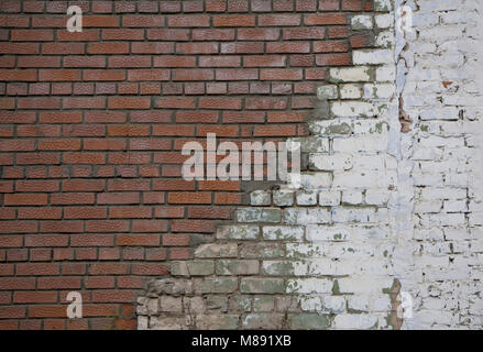 Repair of old brick wall with new white stones White stone wall and plastered red brick wall for background or texture Masonry with different stones B Stock Photo
